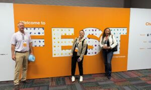 TCDI Team standing in front of FEST sign at RelFest 2025